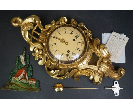 A Westerstrand Swedish wall clock together with a cast iron doorstop. 