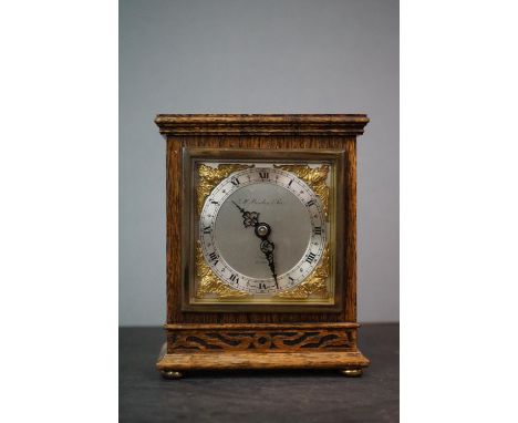 A wooden cased mantle clock marked G.H. Pressley &amp; Sons, Elliott, London. 