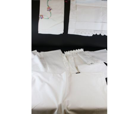 A large collection of vintage white linen table cloths 