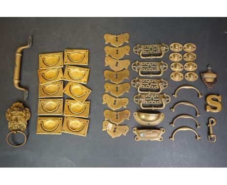 A collection of brass drawer furniture together with a brass door knocker. 