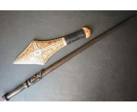 A Soloman Island ceremonial club together with a similar walking stick with carved head decoration. 