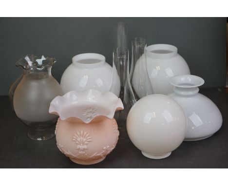 A collection of glass oil lamp shades and chimneys. 