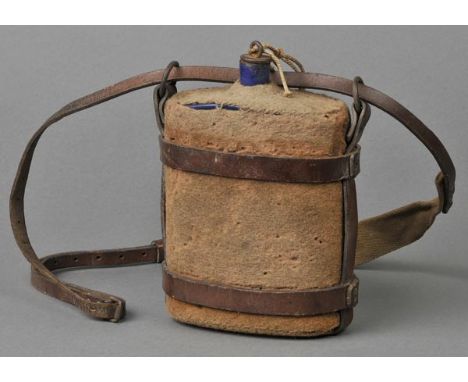 *WWI. A Great War water bottle,  with blue enamel finish covered in felt with cork stopper and brown leather carrying strap w