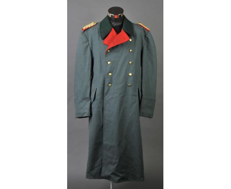 *Third Reich. A General's overcoat,  green cloth with red piping, stamped 'H. Shultz Berlin G.II.A 1944', and later epaulette