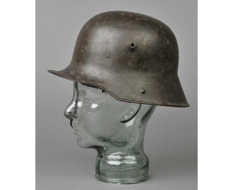 *WWI Helmet. A WWI German steel helmet,  with two large visor lugs, original brown leather lining and chinstrap, stamped B.F6