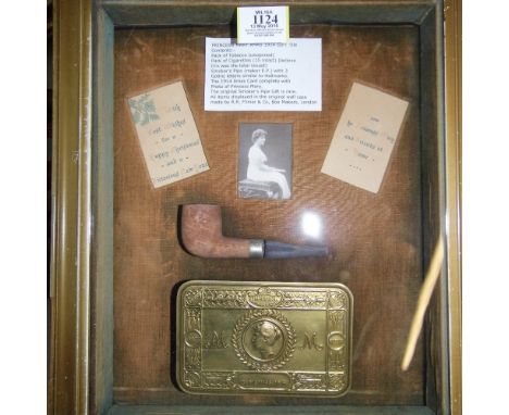 *WWI. A Princess Mary brass Christmas tin containing a packet of tobacco and cigarettes,  presented in a deep frame with Chri