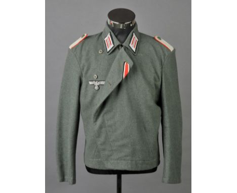 *Third Reich. An Artillery wrapper with collar tabs,  silver bullion epaulettes with red piping, cloth insignia, green compos