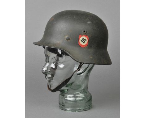 *Third Reich. An SS M35 steel helmet,  field green with SS and party decals, inner comb stamped 854 and Q63, brown leather li