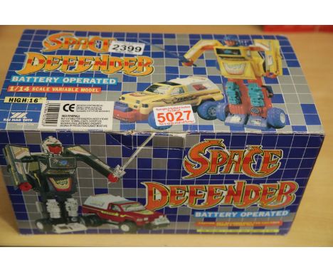 Boxed Space Defenders battery operated transforming car and a battery operated space man robot. P&amp;P Group 1 (£14+VAT for 