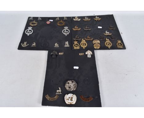 A COLLECTION OF CAP BADGES, collar badges, shoulder titles and a helmet badges, they are a mix of different ages and there ar
