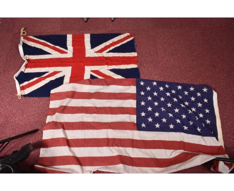 A WWI 1916 DATED UNION JACK FLAG AND A LATER USA FLAG, the Union Jack flag has the broad arrow and WD (War Department) stampe