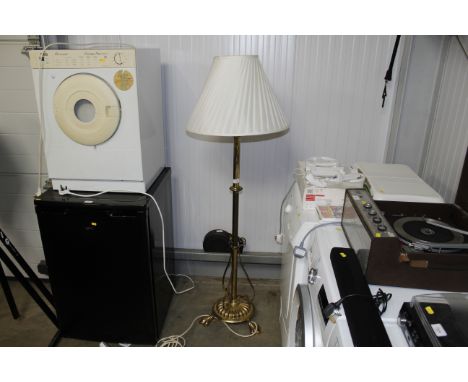 A brass standard lamp and shade