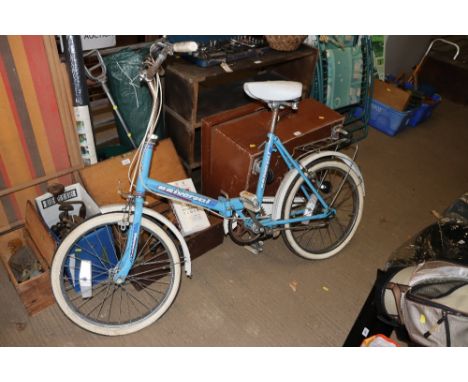A Universal folding bicycle with front and rear mudguard, rear panier rack and side stand