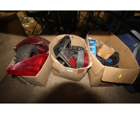 Three boxes of various items to include rear cluster lights, a 4.00-8 tyre as new, rear light clusters to fit a Citroen Saxo 