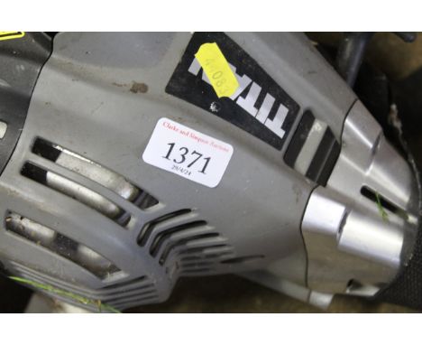 A Titan TTL488GVO petrol 2-in-1 multi tool comprising strimmer and hedge trimmer attachments, with instruction guide