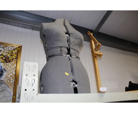 A tailors dummy and a wooden stand 