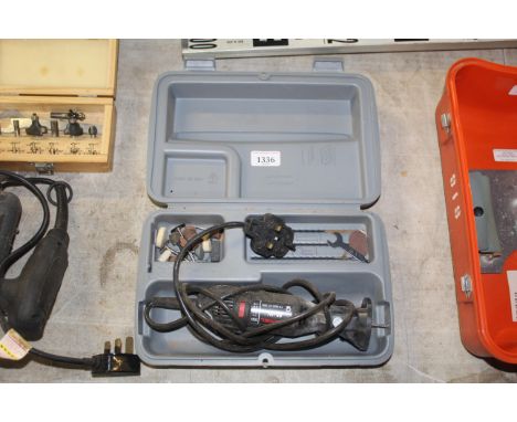 A Dremel multi tool in plastic case with various attachments