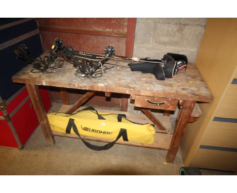 A wooden workbench fitted single drawer and shelf below