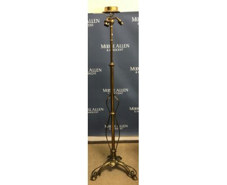 An Art Nouveau brass telescopic lamp standard with three bayonet fixing light holders on a plain adjustable column to stylise