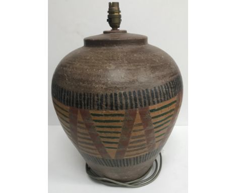 A modern pottery lamp with painted ethnic style decoration, 46 cm high including fitting CONDITION REPORTS Has general wear a