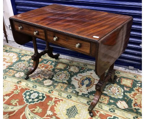 A 19th Century mahogany and cross banded sofa table, the top with reeded edge over two frieze drawers with turned brass knob 