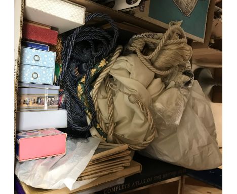 A box containing assorted textiles to include tassel tie backs, vintage newspapers, vintage soap sets etc, a box containing a