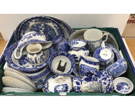 Two crates of assorted blue and white china to include "Willow" pattern wares, a Ringtons tea caddy by Wade Potteries, Copela
