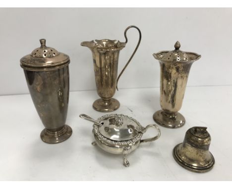 A George V silver cream jug and matching sugar caster with shaped rim on a slender tapered body, raised on circular foot (by 