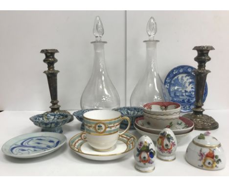 A box containing two modern glass decanters, a pair of silver plated candlesticks, two 18th Century porcelain tea bowls and s