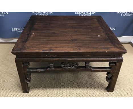 A circa 1900 Chinese hardwood low table, the plank top above a fretwork carved frieze on square supports to scroll feet 95 cm