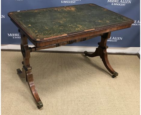 A Regency mahogany writing table, the tooled and gilded leather insert top within a moulded edge, over a rosewood strung plai