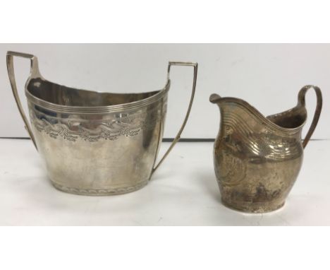 A George III silver oval sugar basin (by Peter, Ann and William Bateman, London 1800), together with a George III silver crea