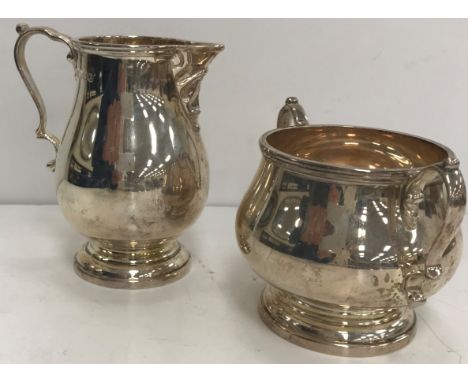 A George VI silver baluster cream jug and matching sugar basin by Charles Boyton &amp; Sons of Sheffield 1942, 14.63 oz