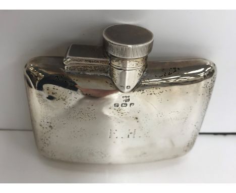 A George V silver hip flask of slightly curved form inscribed "E.H." (by William Neale &amp; Son Ltd., Birmingham 1924), 9.6 