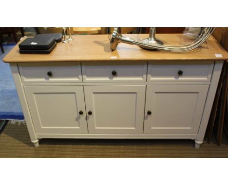 A LAURA ASHLEY SIDEBOARD having light oak effect top over three inline drawers, and three cupboard doors, dimensions are 142c