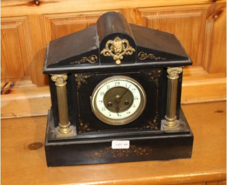 A LATE VICTORIAN BLACK SLATE MANTEL CLOCK of architectural proportions, having cast gilt metal lion crest over a circular dia