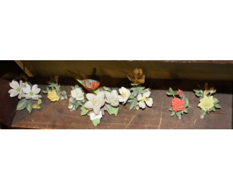 A PAINTED ROYAL WORCESTER CERAMIC MODEL OF A ROBIN amongst the foliage, together with six other floral models 