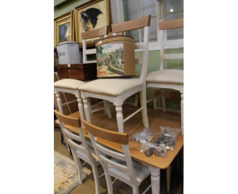 A BELIEVED LAURA ASHLEY BRANDED DINING SUITE, having extending light oak topped table on painted leg base, with eight single 