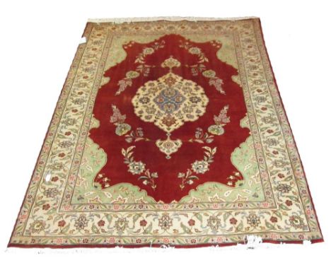 VERY FINE TABRIZ, 278cm x 173cm, pendant medallion on a ruby field with palmettes and vines within an ivory border.