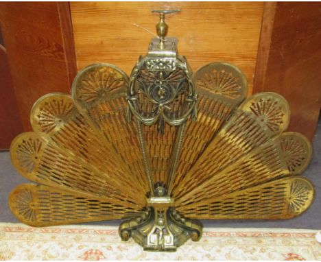 FIRESCREEN, early 20th century gilt metal of fan shape with radiating brass petals, 68cm H x 98cm.