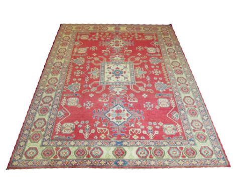 FINE KAZAK DESIGN CARPET, 316cm x 233cm, ivory medallions and other motifs on ruby field. 