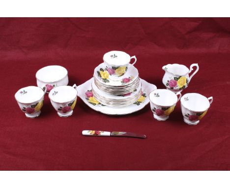 A Royal Albert tea service in the 'June Delight' pattern. Comprising five cups, six saucers, a sugar bowl, cream jug, six pla