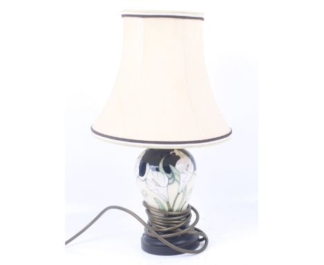 A contemporary Moorcroft table lamp base. Decorated with flowers, with a white shade, H19cm