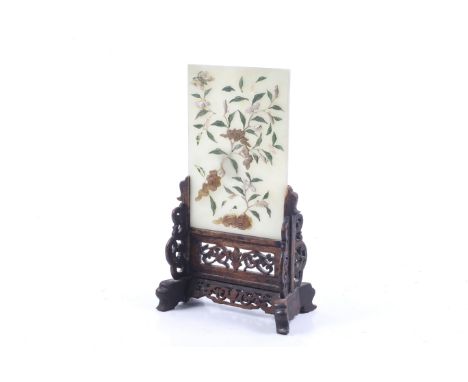 A Chinese jade table screen. The pale celadon plaque applied with hardstone rocks, flower and leaves, in a fitted pierced and