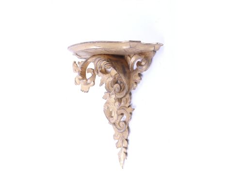 A contemporary Rococo style carved gilt wood wall bracket. With leaf and scroll decoration and a moulded edge shelf. H37cm. 