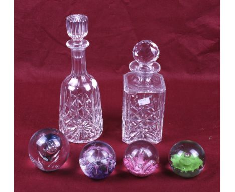Two 20th century decanters and four paperweights. One of the decanters of tapered form with a ribbed stopper, H30cm, the othe