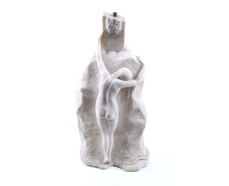 A contemporary carved white marble lamp base. Modelled as a nude female clutching against a rock, H46cm
