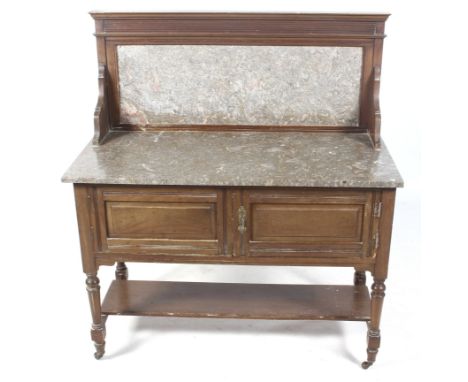 An Edwardian marble topped mahogany wash stand. Marble gallery back above a two door cupboard, with turned tapering supports,