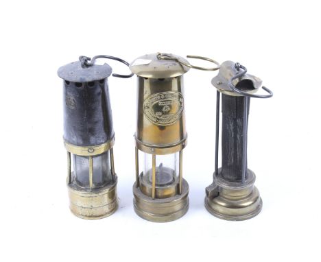 Three vintage miners lamps. Including an E Thomas & Williams Ltd brass example, No 30470, H25.5cm