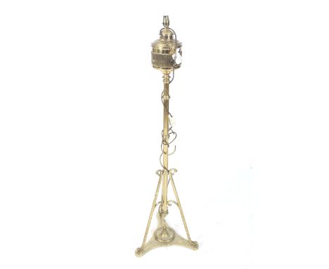 A converted brass floor standing oil lamp. With a tripod base. H140cm